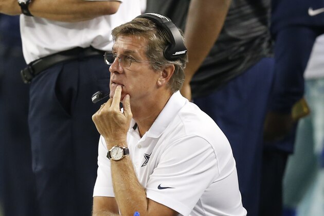 Oct 27, 2014; Arlington, TX, USA; Dallas Cowboys offensive coordinator Bill Callahan kneels on the sidelines against the Washington Redskins at AT&T Stadium. Mandatory Credit: Matthew Emmons-USA TODAY Sports