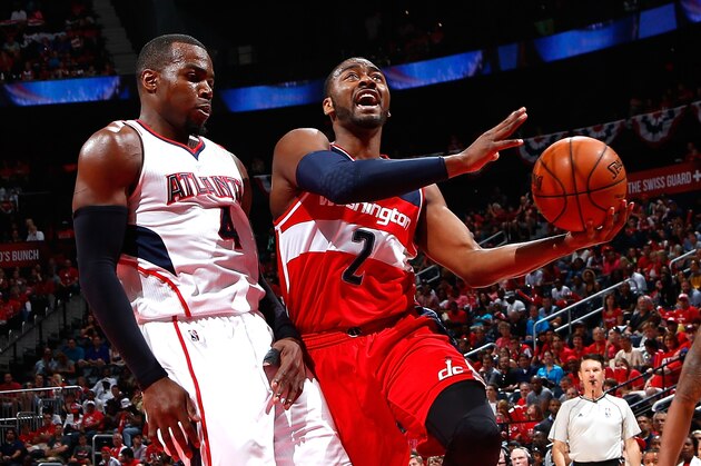 ATLANTA, GA - MAY 03:  John Wall #2 of the Washington Wizards drives against Paul Millsap #4 of the Atlanta Hawks during Game One of the Eastern Conference Semifinals of the 2015 NBA Playoffs at Philips Arena on May 3, 2015 in Atlanta, Georgia.  NOTE TO USER: User expressly acknowledges and agrees that, by downloading and/or using this photograph, user is consenting to the terms and conditions of the Getty Images License Agreement.  (Photo by Kevin C. Cox/Getty Images)