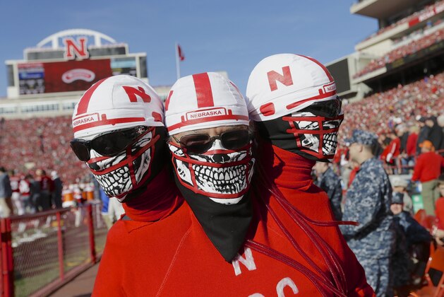 A Nebraska fan carries extra heads in the first half of an NCAA college football game against Purdue in Lincoln, Neb., Saturday, Nov. 1, 2014. (AP Photo/Nati Harnik)