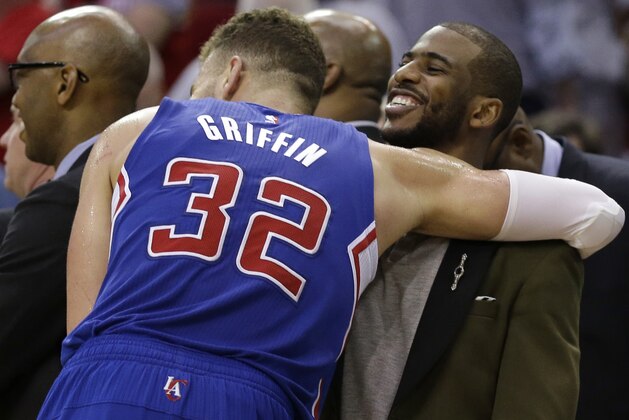 Los Angeles Clippers' Blake Griffin (32) hugs teammate Chris Paul following Game 1 in a second-round NBA basketball playoff series against the Houston Rockets, Monday, May 4, 2015, in Houston. Chris Paul is out for game 1 with a strained left hamstring. Los Angeles won 117-101. (AP Photo/David J. Phillip)