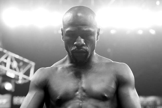 LAS VEGAS, NV - MAY 02:  (EDITORS NOTE: Image has been converted to black and white.) Floyd Mayweather Jr. looks down before taking on Manny Pacquiao in their welterweight unification championship bout on May 2, 2015 at MGM Grand Garden Arena in Las Vegas, Nevada.  (Photo by Al Bello/Getty Images)