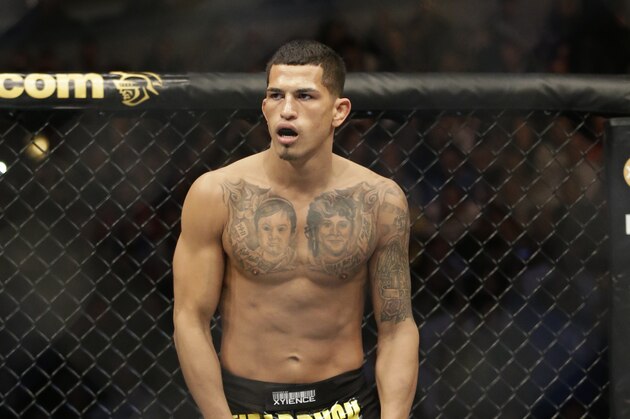 Anthony Pettis runs on the ring before fighting with Donald Cerrone during UFC Lightweight Championship on FOX 6 at the United Center in Chicago, Saturday, Jan. 26, 2013. Pettis won the bout. (AP Photo/Nam Y. Huh)