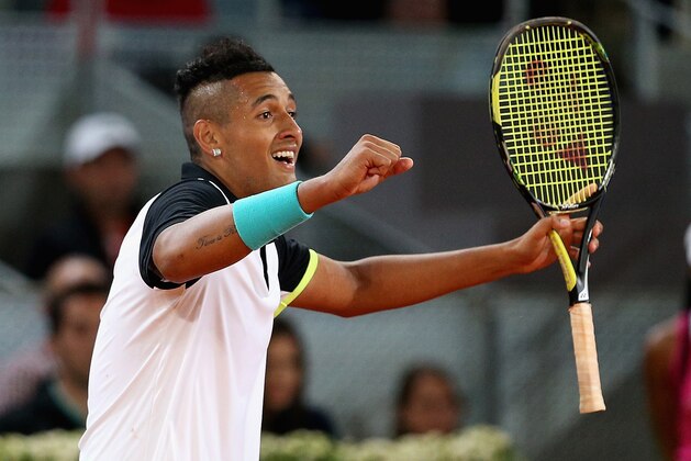 MADRID, SPAIN - MAY 06:  Nick Kyrgios of Australia celebrates match point against Roger Federer of Switzerland in their second round match during day five of the Mutua Madrid Open tennis tournament at the Caja Magica  on May 6, 2015 in Madrid, Spain.  (Photo by Clive Brunskill/Getty Images)