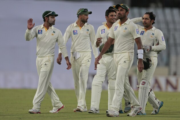 Pakistan’s players walk back to the pavilion at the end of the second day of the second test cricket match against Bangladesh in Dhaka, Bangladesh, Thursday, May 7, 2015. (AP Photo/ A.M. Ahad)