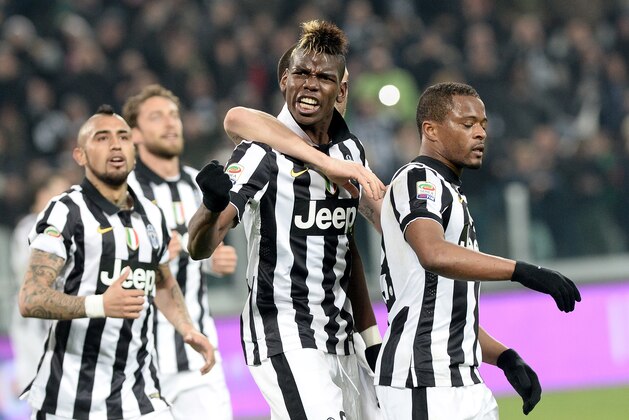 Juventus' Paul Pogba, foreground, celebrates with his teammates after scoring during a Serie A soccer match between Juventus and Sassuolo at the Juventus stadium, in Turin, Italy, Monday, March 9, 2015. Juventus won 1-0. (AP Photo/Massimo Pinca)