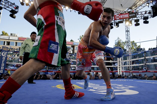Omar Figueroa, right, follows through a punch to Daniel Estrada during their WBC lightweight title boxing bout Saturday, Aug. 16, 2014, in Carson, Calif. (AP Photo/Chris Carlson)