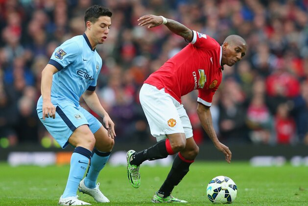 MANCHESTER, ENGLAND - APRIL 12:  Ashley Young of Manchester United evades Samir Nasri of Manchester City during the Barclays Premier League match between Manchester United and Manchester City at Old Trafford on April 12, 2015 in Manchester, England.  (Photo by Alex Livesey/Getty Images)