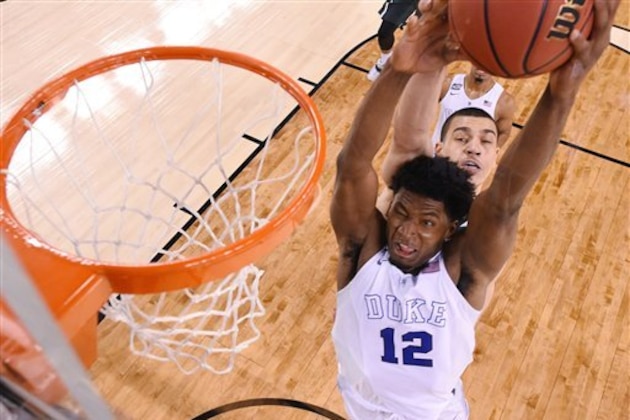 Duke's Justise Winslow (12) is fouled by Michigan State's Gavin Schilling, rear, during the second half of the NCAA Final Four tournament college basketball semifinal game Saturday, April 4, 2015, in Indianapolis. (AP Photo/Chris Steppig, Pool)