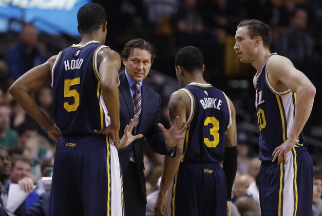 Utah Jazz head coach Quin Snyder talks to guard Rodney Hood (5), guard Trey Burke (3) and forward Gordon Hayward (20) during the second half of an NBA basketball game against the Boston Celtics in Boston, Wednesday, March 4, 2015. The Celtics won 85-84. (AP Photo/Elise Amendola)