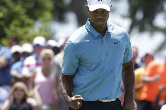 Tiger Woods celebrated a birdie on the ninth hole during the second round of The Players Championship golf tournament Friday, May 8, 2015, in Ponte Vedra Beach, Fla. (AP Photo/Lynne Sladky)