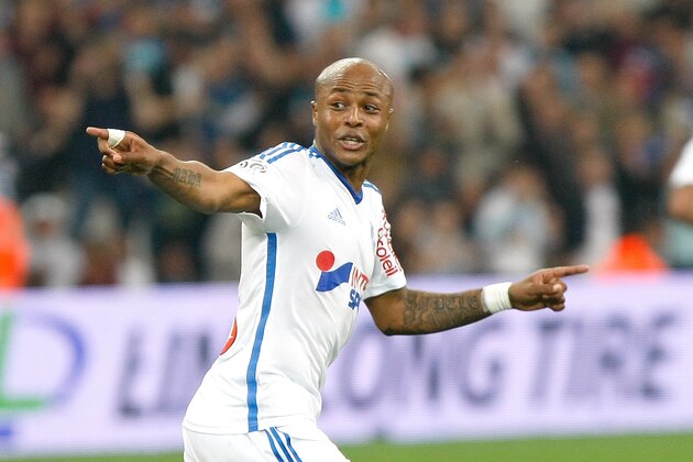 Marseille's Ghanaian forward Andre Ayew,  celebrates  after scoring against Lorient , during the League One soccer match between Marseille and Lorient, at the Velodrome Stadium, in Marseille, southern France, Friday, April 24, 2015. (AP Photo/Claude Paris)