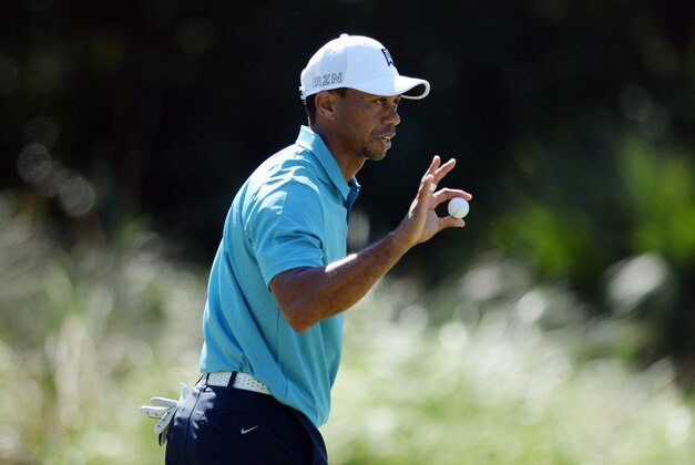 May 8, 2015; Ponte Vedra Beach, FL, USA; Tiger Woods shows his ball to the gallery after putting on the 14th green during the second round of The Players Championship golf tournament at TPC Sawgrass - Stadium Course. Mandatory Credit: Jake Roth-USA TODAY Sports
