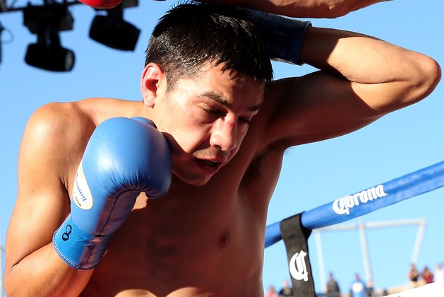 LOS ANGELES, CA - AUGUST 16:  Omar Figueroa Jr. dodges a punch form Daniel Estrada in their WBC Lightweight World Championship fight at StubHub Center on August 16, 2014 in Los Angeles, California.  (Photo by Stephen Dunn/Getty Images)