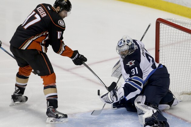 Winnipeg Jets goalie Ondrej Pavelec. right, blocks a shot by Anaheim Ducks center Ryan Kesler during the first period of Game 1 of a first-round NHL hockey playoff series in Anaheim, Calif., Thursday, April 16, 2015. (AP Photo/Chris Carlson)