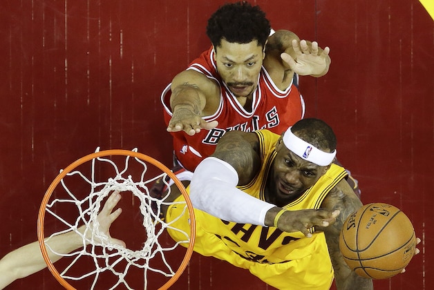 Cleveland Cavaliers forward LeBron James (23) puts up a shot against Chicago Bulls guard Derrick Rose (1) during the first half of Game 2 in a second-round NBA basketball playoff series Wednesday, May 6, 2015, in Cleveland. (AP Photo/Tony Dejak)