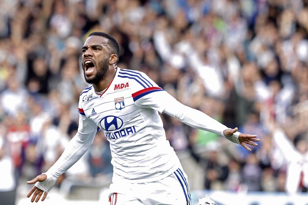Lyon's Alexandre Lacazette celebrates after he scored his first goal against Lille during their French League One soccer match in Lyon, central France, Sunday, Oct. 5, 2014. (AP Photo/Laurent Cipriani)