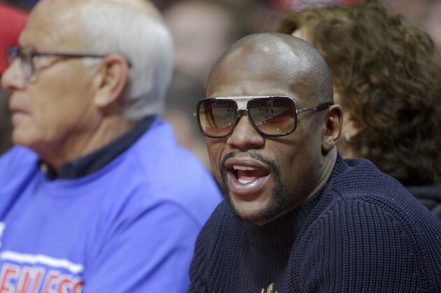 Floyd Mayweather Jr., watches during the first half of Game 3 in a second-round NBA basketball playoff series between the Los Angeles Clippers and the Houston Rockets in Los Angeles, Friday, May 8, 2015. (AP Photo/Jae C. Hong)