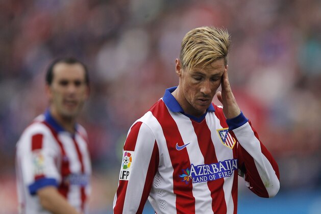 Atletico's Fernando Torres, right, gestures during a Spanish La Liga soccer match between Atletico Madrid and Elche at the Vicente Calderon stadium in Madrid, Spain, Saturday, April 25, 2015. (AP Photo/Andres Kudacki)