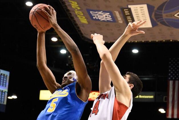 March 13, 2015; Las Vegas, NV, USA; UCLA Bruins forward Kevon Looney (5, left) grabs a rebound against Arizona Wildcats center Dusan Ristic (14) during the first half in the semifinal round of the Pac-12 Conference tournament at MGM Grand Garden Arena. Mandatory Credit: Kyle Terada-USA TODAY Sports