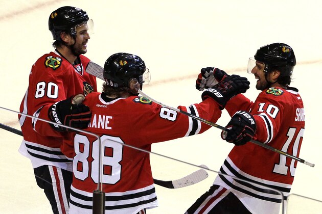 Chicago Blackhawks right wing Patrick Kane (88) celebrates with center Antoine Vermette, left, and left wing Patrick Sharp after scoring his second goal against the Minnesota Wild during the third period  of Game 2 in the second round of the NHL Stanley Cup hockey playoffs in Chicago, Sunday, May 3, 2015. The Blackhawks won 4-1. (AP Photo/Nam Y. Huh)
