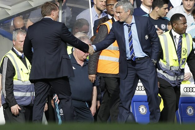 Liverpool's head coach Brendan Rodgers, left, shakes hands with Chelsea's head coach Jose Mourinho at the end of the English Premier League soccer match between Chelsea and Liverpool at Stamford Bridge stadium in London, Sunday, May 10,  2015. The game ended in a 1-1 draw. (AP Photo/Matt Dunham)