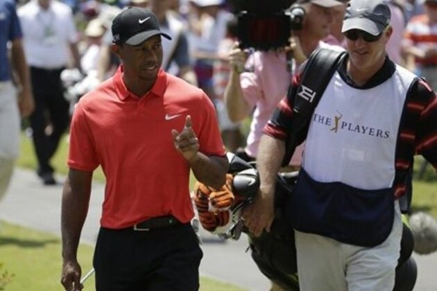 Tiger Woods, left,  and caddie Jo La Cava walk to 17 green during the final round of The Players Championship golf tournament Sunday, May 10, 2015, in Ponte Vedra Beach, Fla. (AP Photo/Lynne Sladky)