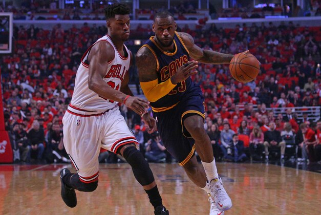 May 10, 2015; Chicago, IL, USA; Cleveland Cavaliers forward LeBron James (23) dribbles the ball as Chicago Bulls guard Jimmy Butler (21) defends in the first quarter of game four of the second round of the NBA Playoffs at the United Center. Mandatory Credit: Dennis Wierzbicki-USA TODAY Sports
