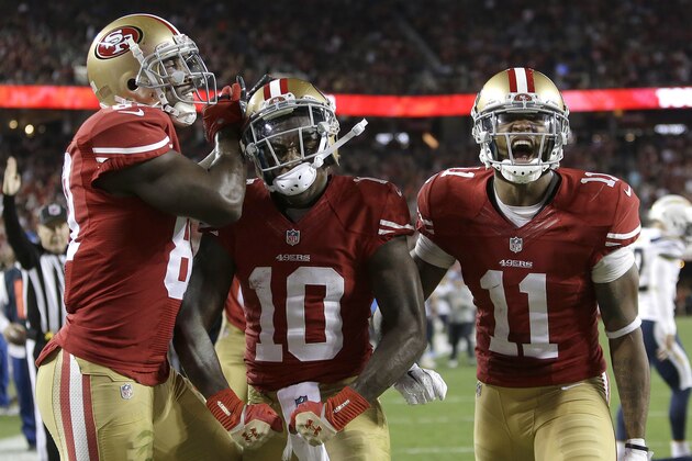 San Francisco 49ers wide receiver Bruce Ellington (10) celebrates after scoring on 1-yard touchdown run, with wide receivers Anquan Boldin (81) and Quinton Patton (11) during the second quarter of an NFL football game against the San Diego Chargers in Santa Clara, Calif., Saturday, Dec. 20, 2014. (AP Photo/Marcio Jose Sanchez)