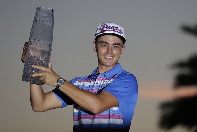 Rickie Fowler holds during the The Players Championship trophy, Sunday, May 10, 2015, in Ponte Vedra Beach, Fla. Fowler won in a sudden death playoff against Kevin Kisner. (AP Photo/John Raoux)