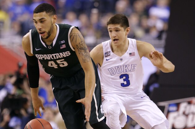 Michigan State's Denzel Valentine (45) drives up court past Duke's Grayson Allen, right, during the first half of the NCAA Final Four tournament college basketball semifinal game Saturday, April 4, 2015, in Indianapolis. (AP Photo/Michael Conroy)