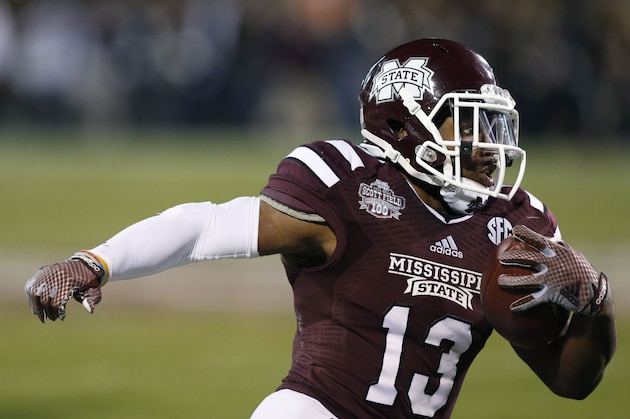 Mississippi State running back Josh Robinson (13) runs for short yardage in the first half of an NCAA college football game against Vanderbilt, Saturday, Nov. 22, 2014, in Starkville, Miss. No. 4 Mississippi State won 51-0. (AP Photo/Rogelio V. Solis)