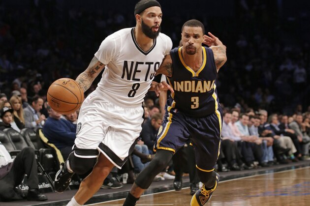 Brooklyn Nets guard Deron Williams (8) drives past Indiana Pacers guard George Hill (3) in the first half of an NBA basketball game at the Barclays Center, Tuesday, March 31, 2015, in New York. (AP Photo/Kathy Willens)