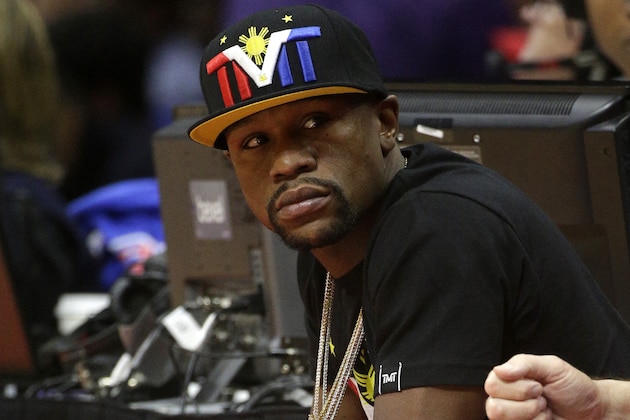 Floyd Mayweather, Jr. watches during the first half in Game 4 of a second-round NBA basketball playoff series between the Los Angeles Clippers and the Houston Rockets, Sunday, May 10, 2015, in Los Angeles. (AP Photo/Jae C. Hong)