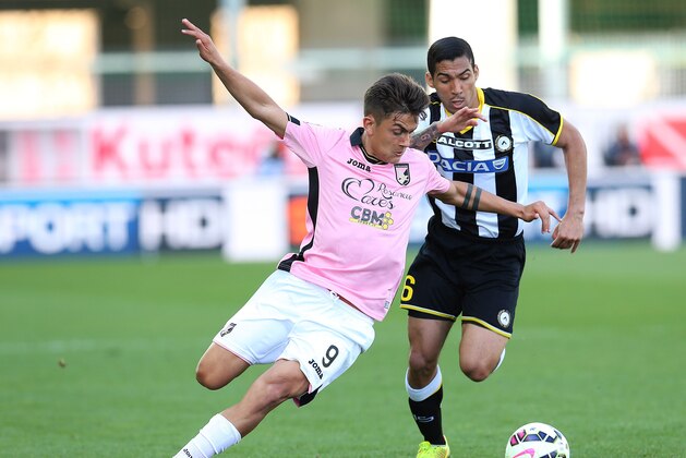Palermo's Paulo Dybala, left, and Udinese's Allan go for the ball during the Serie A soccer match between Udinese and Palermo at the Friuli Stadium in Udine, Italy, Sunday, April 12, 2015. (AP Photo/Paolo Giovannini)