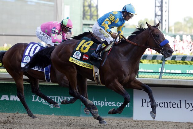 May 2, 2015; Louisville, KY, USA; Victor Espinoza aboard American Pharoah passes Gary L Stevens aboard Firing Line to win 141st Kentucky Derby at Churchill Downs. Mandatory Credit: Peter Casey-USA TODAY Sports