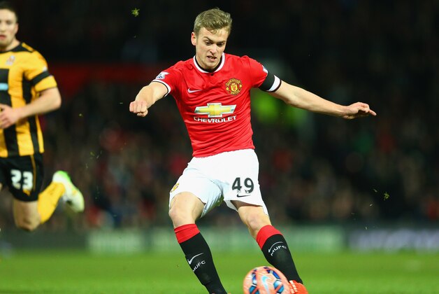 MANCHESTER, ENGLAND - FEBRUARY 03: James Wilson of Manchester United scores the third goal during the FA Cup Fourth round replay match between Manchester United and Cambridge United at Old Trafford on February 3, 2015 in Manchester, England.  (Photo by Clive Mason/Getty Images)