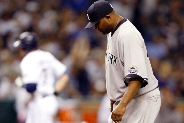 New York Yankees starting pitcher CC Sabathia, right, reacts as Tampa Bay Rays' Evan Longoria rounds the bases after his fourth inning home run of a baseball game Tuesday, July 28, 2009, in St. Petersburg, Fla. The Rays won 6-2. (AP Photo/Mike Carlson)