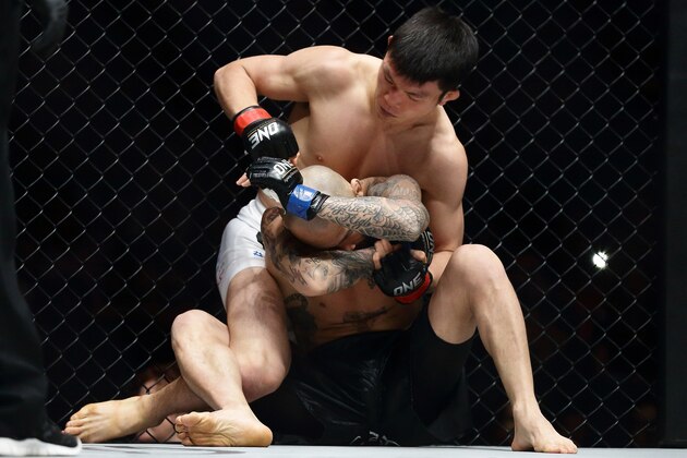 SINGAPORE - APRIL 05:  Shinya Aoki of Japan (back) fights Kotetsu Boku of Japan for the Lightweight World Championship bout during the One Fighting Championship at Singapore Indoor Stadium on April 5, 2013 in Singapore.  (Photo by Suhaimi Abdullah/Getty Images)