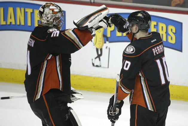 Anaheim Ducks' Corey Perry, right, and goalie Frederik Andersen, of Denmark, celebrate the team's 3-0 win against the Calgary Flames in Game 2 in the second round of the NHL Stanley Cup hockey playoffs, Sunday, May 3, 2015, in Anaheim, Calif. (AP Photo/Jae C. Hong)