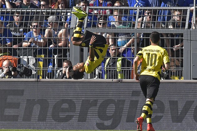 Dortmund's Pierre-Emerick Aubameyang from Gaboon celebrates his goal with a somersault  beside scorer Dortmund's Henrikh Mkhitaryan from Armenia, right, during the German Bundesliga soccer match between Borussia Dortmund and SC Paderborn in Dortmund, Germany, Saturday, April 18, 2015. (AP Photo/Martin Meissner)