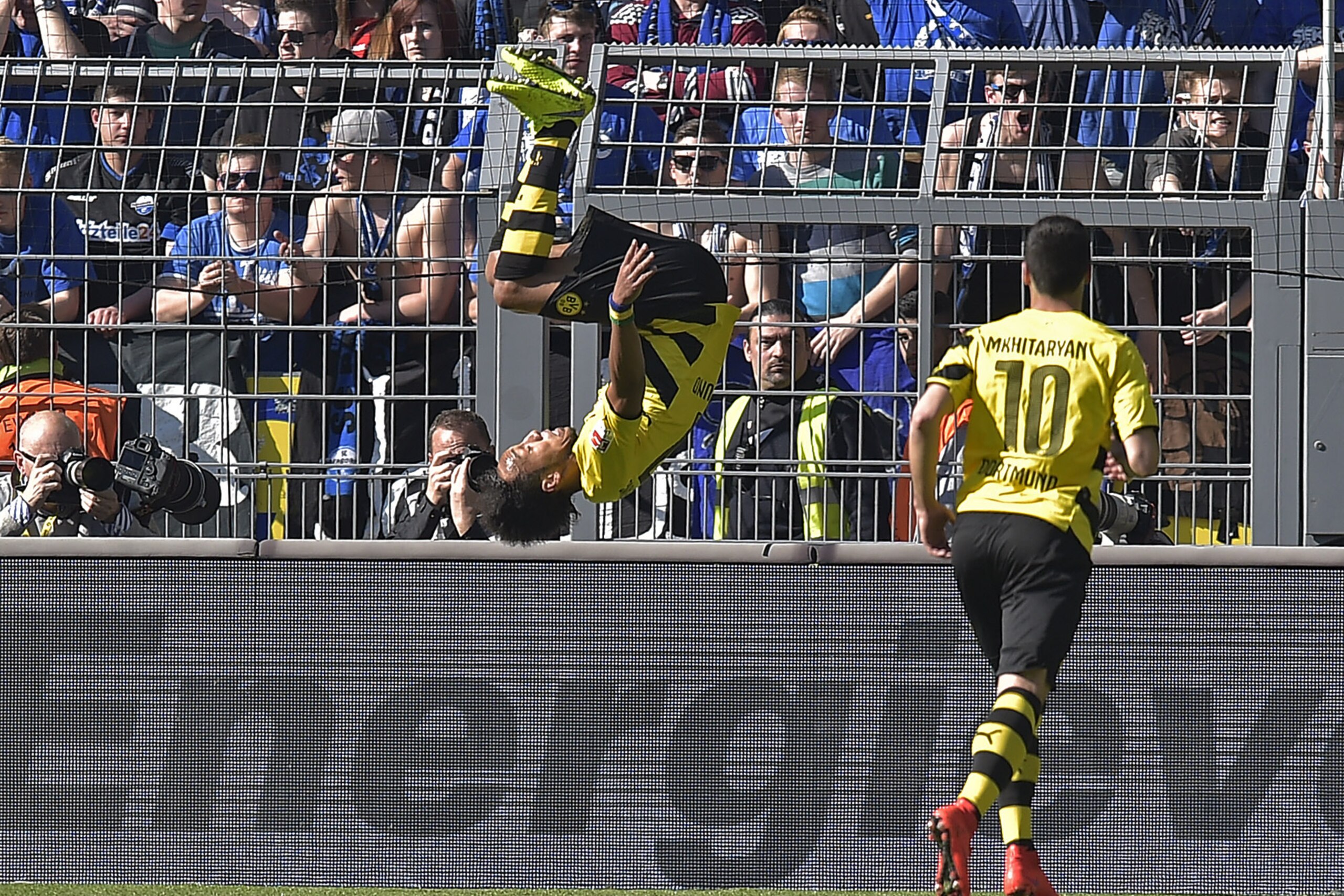 Dortmund's Pierre-Emerick Aubameyang from Gaboon celebrates his goal with a somersault  beside scorer Dortmund's Henrikh Mkhitaryan from Armenia, right, during the German Bundesliga soccer match between Borussia Dortmund and SC Paderborn in Dortmund, Germany, Saturday, April 18, 2015. (AP Photo/Martin Meissner)