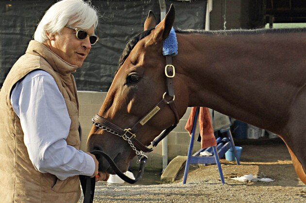 FILE - In this Sunday, May 3, 2015, file photo, Hall of Fame trainer Bob Baffert, left, feeds Kentucky Derby winner American Pharoah a carrot at Churchill Downs in Louisville, Ky., Sunday, May 3, 2015. Like almost every Kentucky Derby winner before him, American Pharoah is facing the inevitable question of whether he can win the Triple Crown. It hasn't been done since 1978, and with him and third-place Dortmund both trained by Baffert, it'll be interesting to see what happens at the Preakness. (AP Photo/Garry Jones, File)
