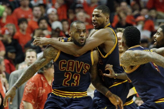 Cleveland Cavaliers' LeBron James, left, celebrates with teammates after scoring the game-winning basket during the second half of Game 4 in a second-round NBA basketball playoff series against the Chicago Bulls in Chicago on Sunday, May 10, 2015. The Cavaliers won 86-84. (AP Photo/Nam Y. Huh)
