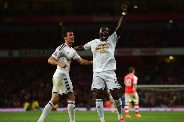 LONDON, ENGLAND - MAY 11:  Bafetibis Gomis of Swansea City (R) celebrates scoring the opening goal with Jack Cork of Swansea City  during the Barclays Premier League match between Arsenal and Swansea City at Emirates Stadium on May 11, 2015 in London, England.  (Photo by Jamie McDonald/Getty Images)