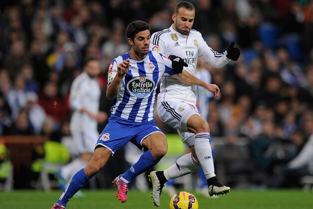 MADRID, SPAIN - FEBRUARY 15:  Jese Rodriguez of Real Madrid tackles Juan Dominguez of RC Deportivo La Coruna during the La Liga match between Real Madrid CF and RC Deportivo La Coruna at Estadio Santiago Bernabeu on February 15, 2015 in Madrid, Spain.  (Photo by Denis Doyle/Getty Images)