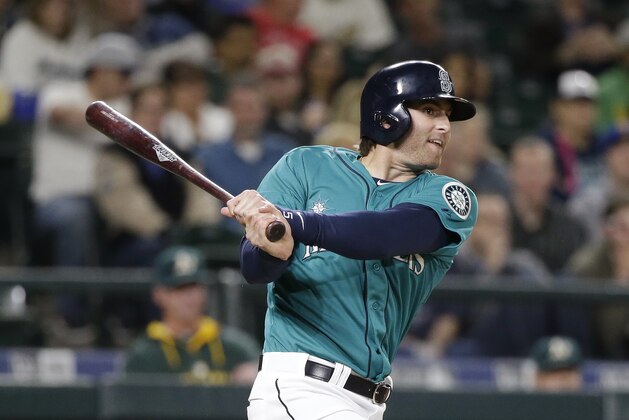 Seattle Mariners' Brad Miller doubles in a run against the Oakland Athletics in the seventh inning of a baseball game Friday, May 8, 2015, in Seattle. (AP Photo/Elaine Thompson)