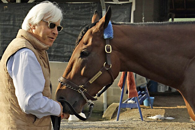 FILE - In this Sunday, May 3, 2015, file photo, Hall of Fame trainer Bob Baffert, left, feeds Kentucky Derby winner American Pharoah a carrot at Churchill Downs in Louisville, Ky., Sunday, May 3, 2015. Like almost every Kentucky Derby winner before him, American Pharoah is facing the inevitable question of whether he can win the Triple Crown. It hasn't been done since 1978, and with him and third-place Dortmund both trained by Baffert, it'll be interesting to see what happens at the Preakness. (AP Photo/Garry Jones, File)