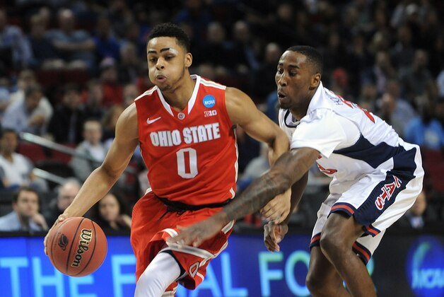 Ohio State guard D'Angelo Russell, left, drives past Arizona forward Rondae Hollis-Jefferson during an NCAA college basketball tournament round of 32 game in Portland, Ore., Saturday, March 21, 2015. (AP Photo/Greg Wahl-Stephens)