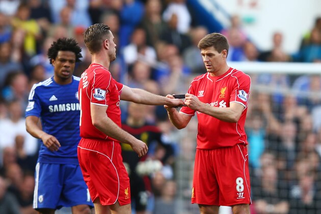 LONDON, ENGLAND - MAY 10:  Steven Gerrard of Liverpool hands the captain's armband to Jordan Henderson of Liverpool as he is substiytuted in the second half during the Barclays Premier League match between Chelsea and Liverpool at Stamford Bridge on May 10, 2015 in London, England.  (Photo by Clive Rose/Getty Images)