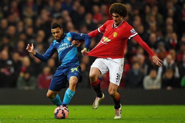 MANCHESTER, ENGLAND - MARCH 09:  Francis Coquelin of Arsenal is challenged by Marouane Fellaini of Manchester United during the FA Cup Quarter Final match between Manchester United and Arsenal at Old Trafford on March 9, 2015 in Manchester, England.  (Photo by Laurence Griffiths/Getty Images)